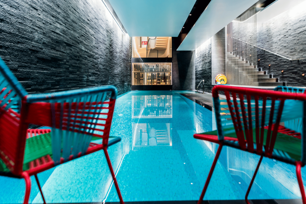 a basement renovation project featuring a swimming pool looking through into a Sorrells wine cellar