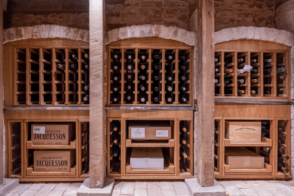 A basement wine cellar with custom made wine racks to fit into the snug space
