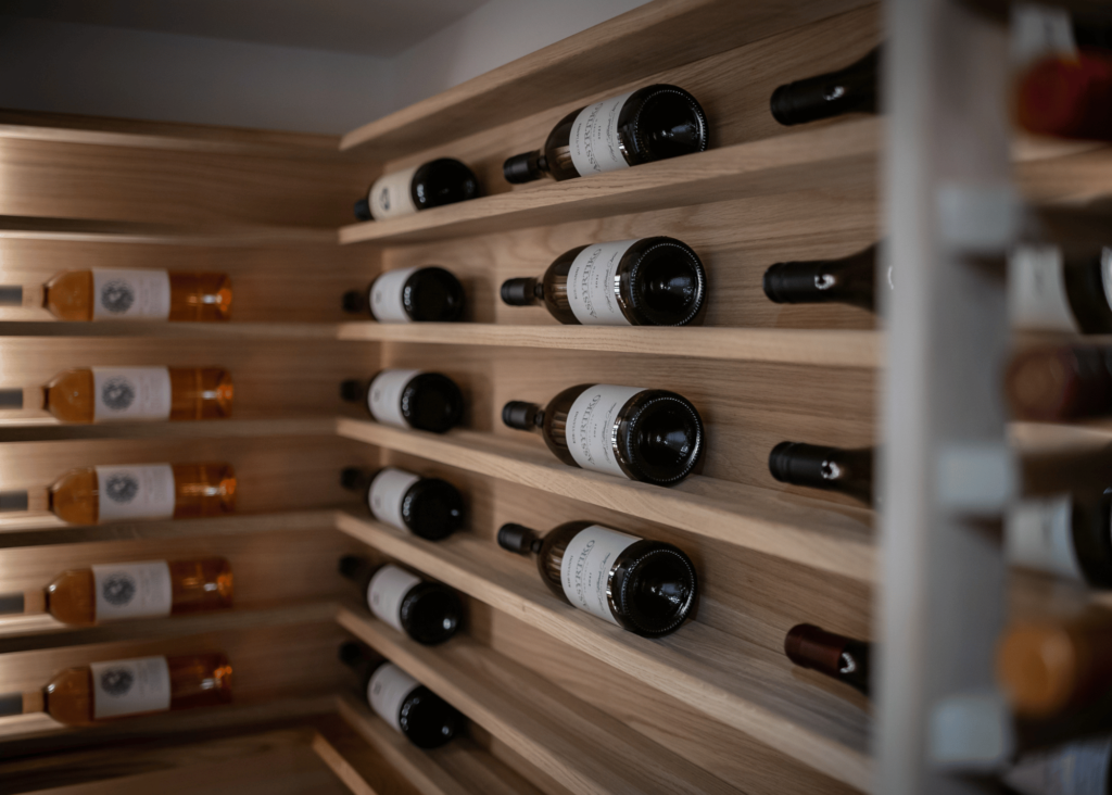 "Scallop racking displaying elegant wine rack with a modern twist, showcasing a collection of fine wines organised beautifully in a stylish and functional manner."