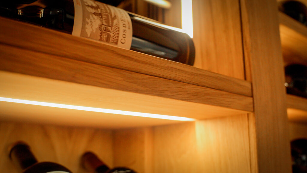 integrated LED strip lighting into an understairs wine cellar.